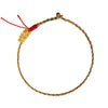 Gold-tone dragon charm on a multi-colored braided cord bracelet