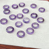Small natural amethyst round rings scattered on a white surface