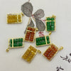 Small jade abacus pendants in green, yellow, and red with gold-tone frames