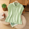 Light green sleeveless cotton shirt with a collar and drawstring hem displayed on a hanger