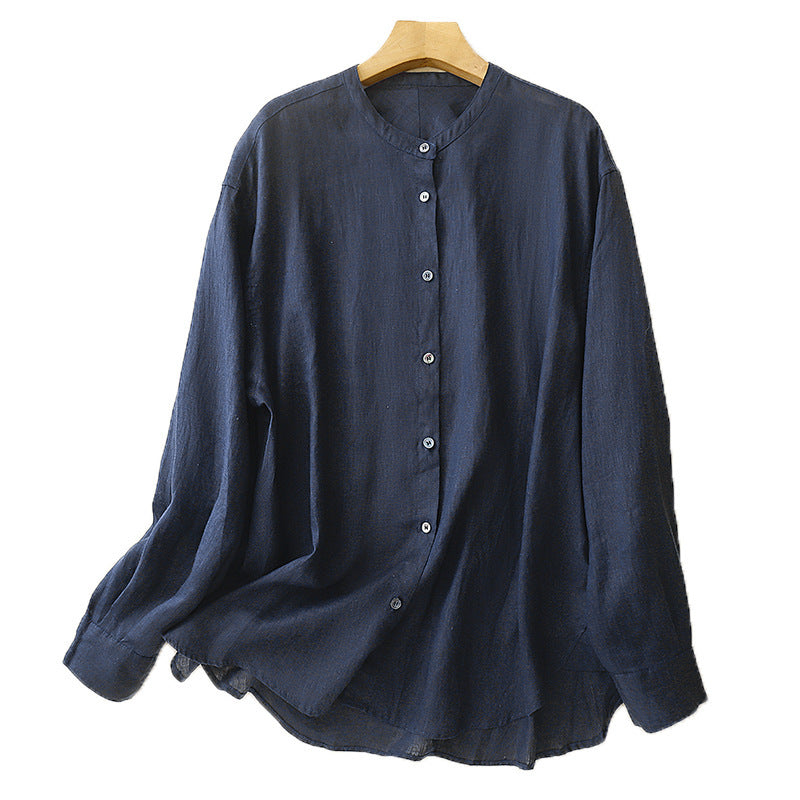 Back view of a white long sleeve cotton shirt hanging on a wooden hanger