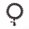 Dark carved wood bracelet with mantra beads and gourd charm on white background