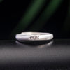 Close up of a vintage silver ring with a lotus flower engraving
