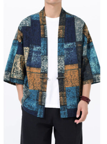 Man wearing a blue and gold patchwork print open front kimono jacket
