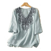 Light blue embroidered V-neck cotton linen t-shirt on a wooden hanger