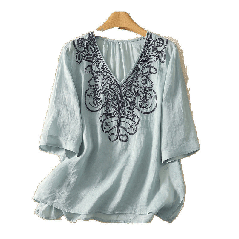 Light blue embroidered V-neck cotton linen t-shirt on a wooden hanger