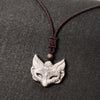 Carved obsidian fox mask pendant on a dark braided cord