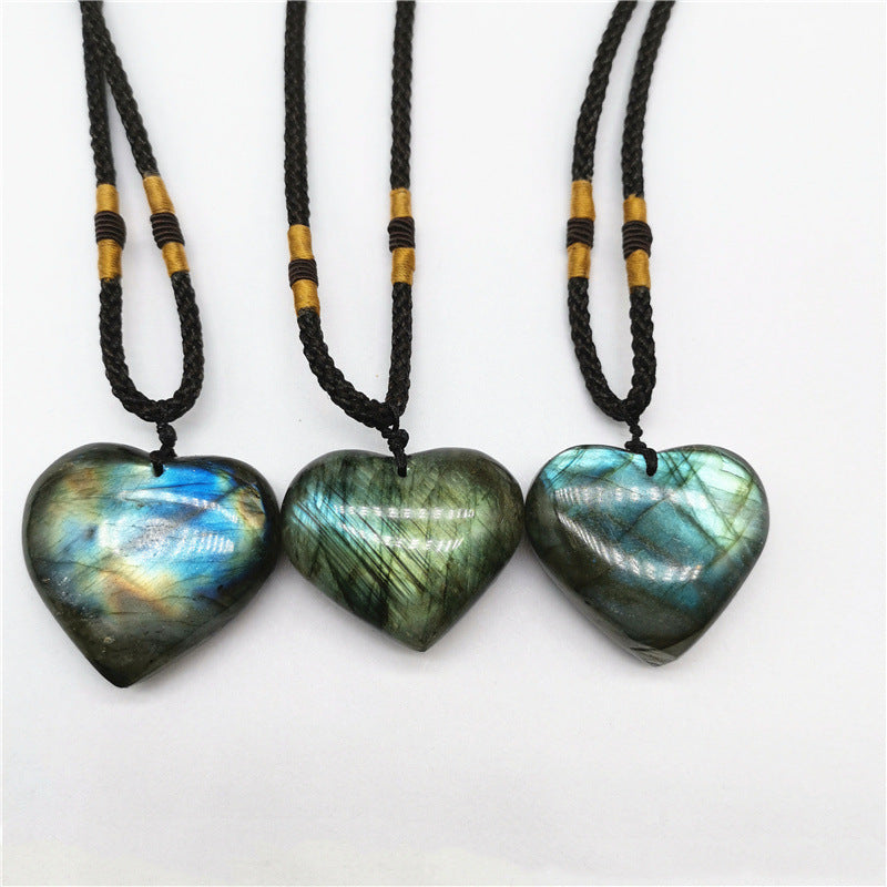 Three heart shaped labradorite pendants on black cords with gold beads