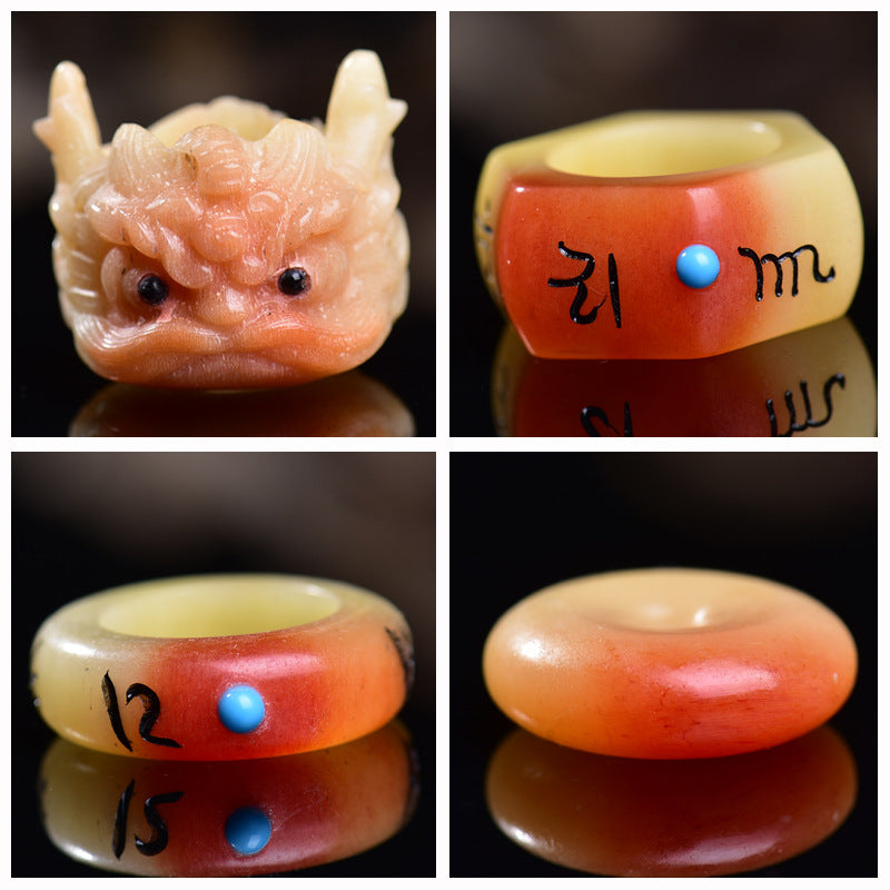 Close up of a carved camel bone ring shaped like a dragon head