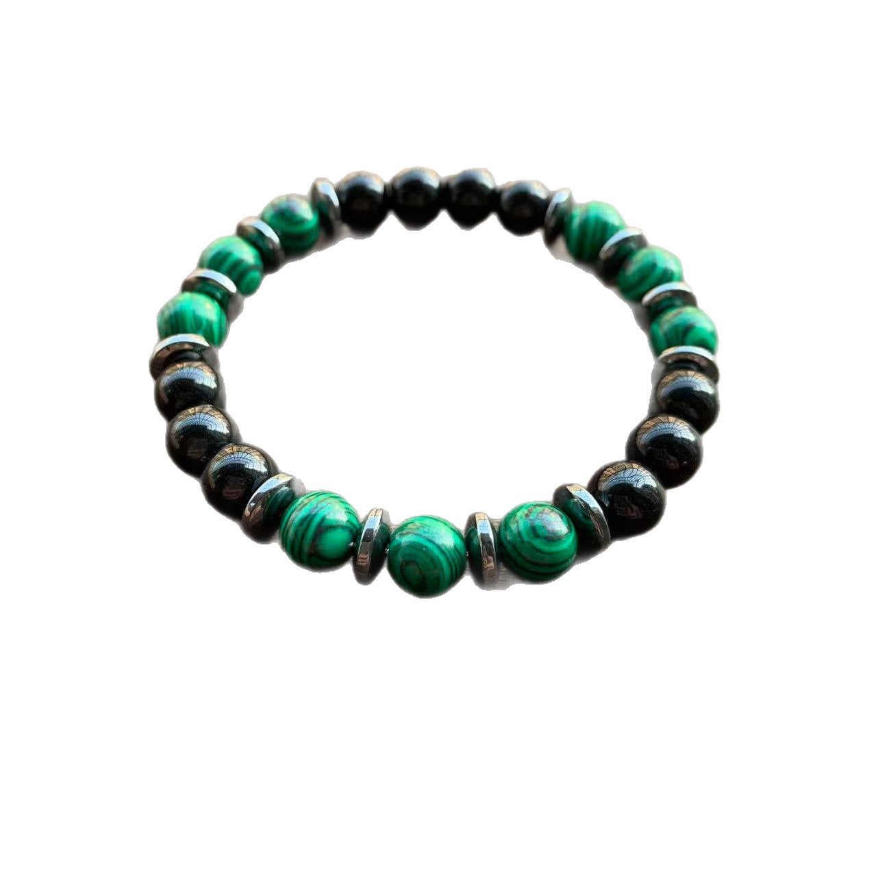Close up of a green and black beaded glass bracelet on a wooden surface