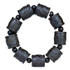 Close up of dark carved wooden barrel beads featuring the eighteen arhats design