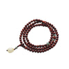 Triple wrap red sandalwood mala bracelet with jade pendant on brown background