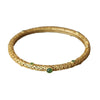 Close up of gold plated copper bangle with green jade stones and carved cloud patterns
