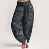 Model wearing dark grey women's harem pants with cloud and mountain pattern