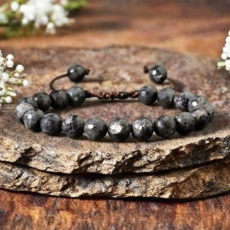 Faceted dark grey natural stone beads on a brown woven cord bracelet