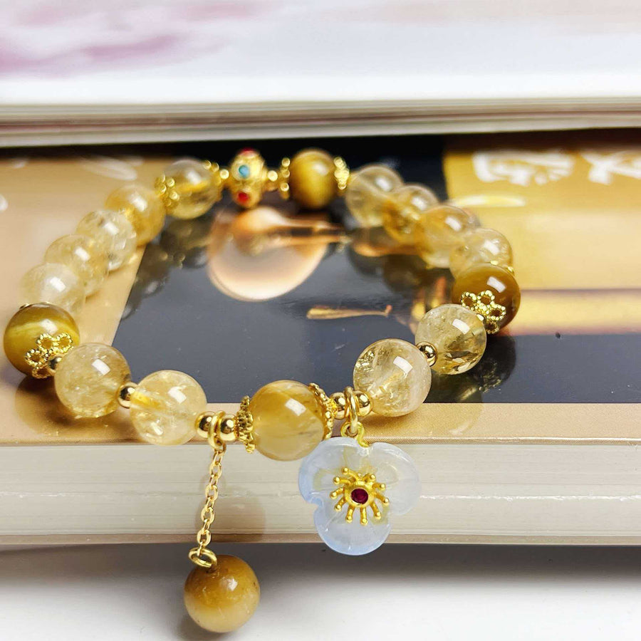 Handmade natural citrine beaded bracelet with a white flower charm and gold-tone accents