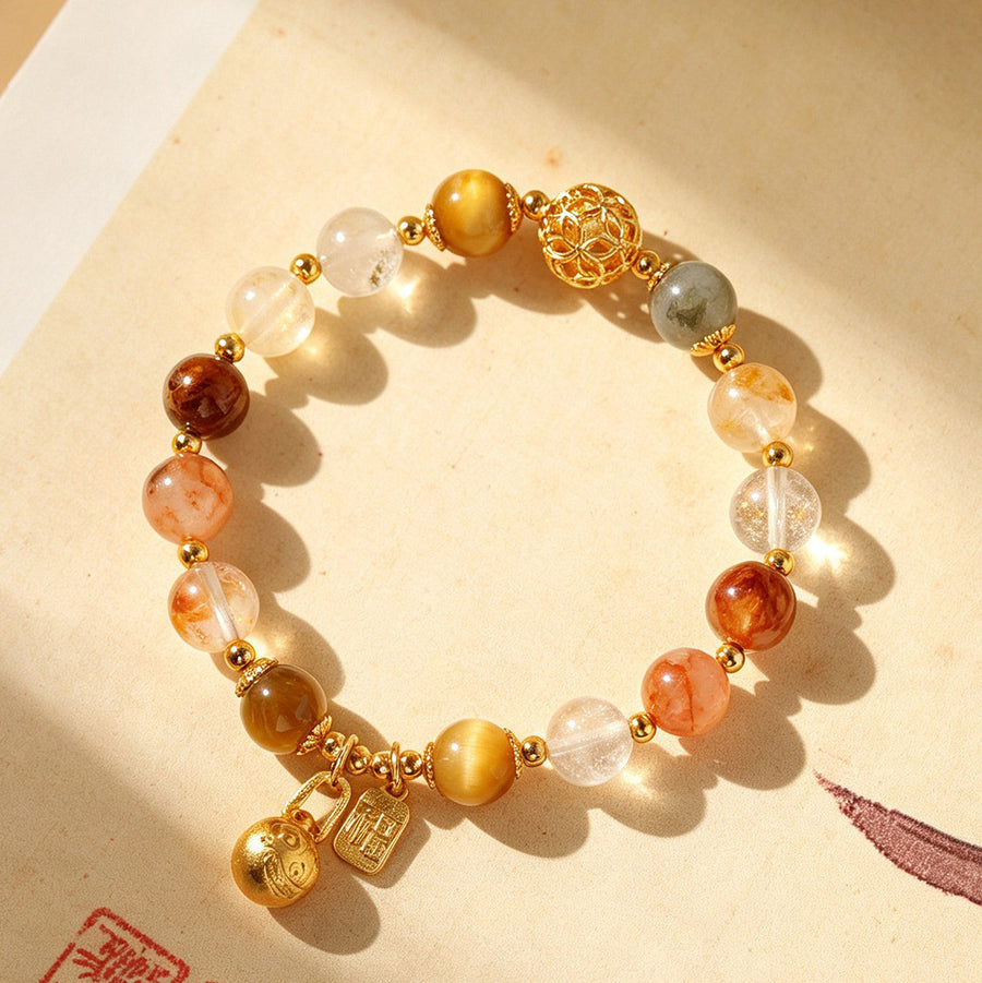 Close-up of a multi-colored crystal beaded bracelet with gold-tone charms on a beige background