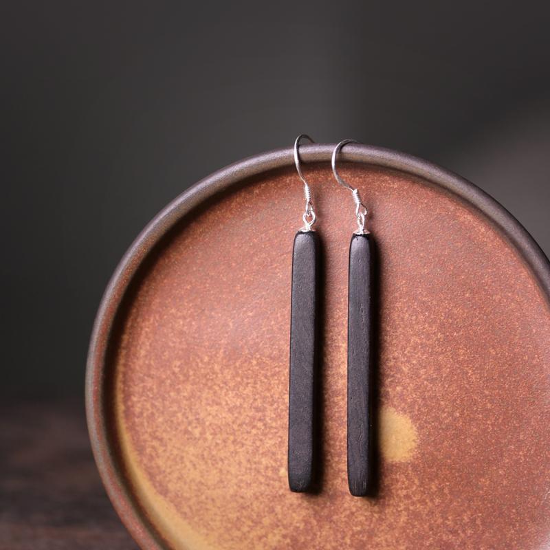 Pair of long, rectangular black wood dangle earrings on silver hooks