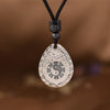 Silver tone water drop pendant with Yin Yang and Bagua design on a black cord