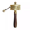 Close-up of a gold-tone Tibetan prayer wheel showing detailed engravings on the cylinder.