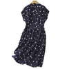 Back view of a navy blue polka dot midi dress on a hanger showing the A-line shape