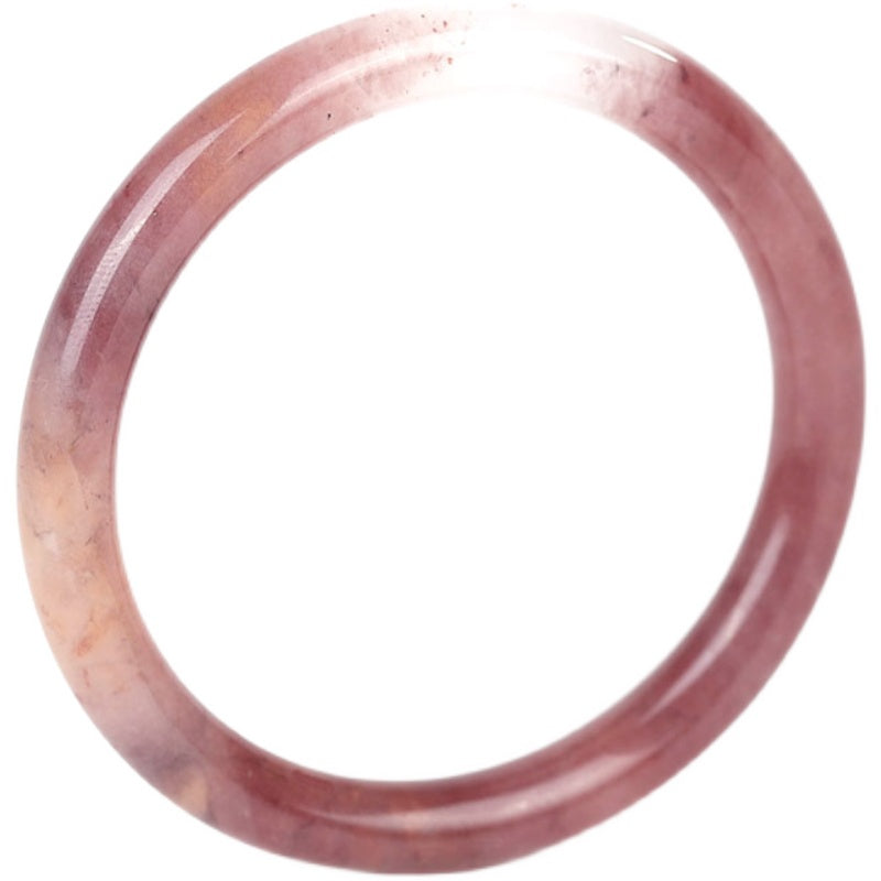 A hand wearing a translucent purple jade bangle against a black background