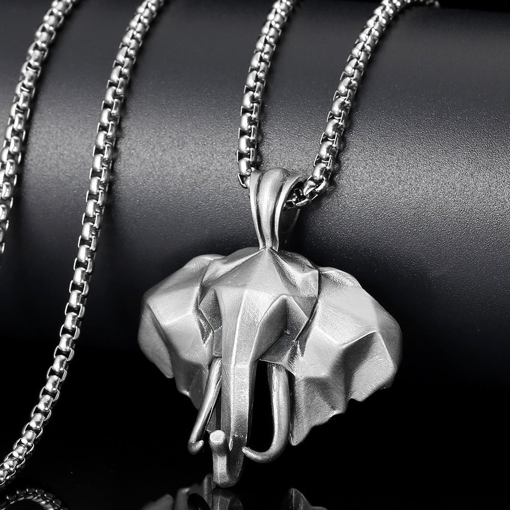 Close up view of a silver 3D elephant head pendant on a metal chain