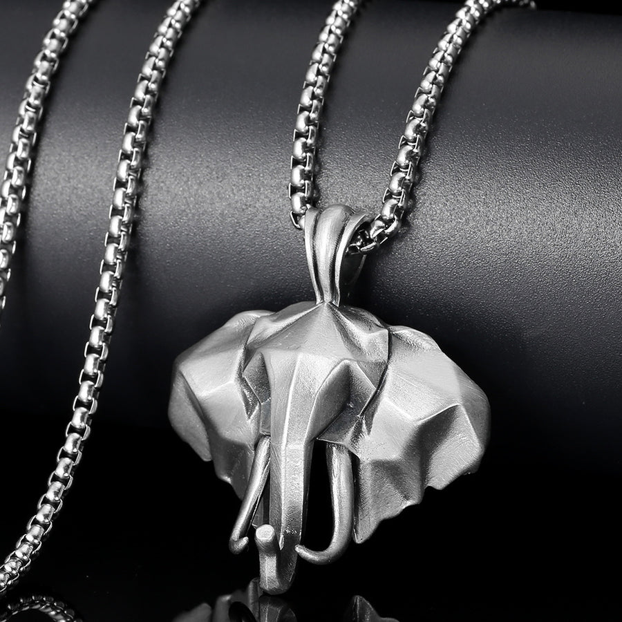 Close up view of a silver 3D elephant head pendant on a metal chain