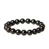 A close-up view of a polished black obsidian beaded bracelet on a white background