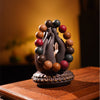 Multi-colored scented bead bracelet displayed on a hand-shaped stand