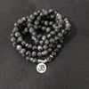 Coiled 108 bead black glitter stone mala bracelet with silver tone Om charm