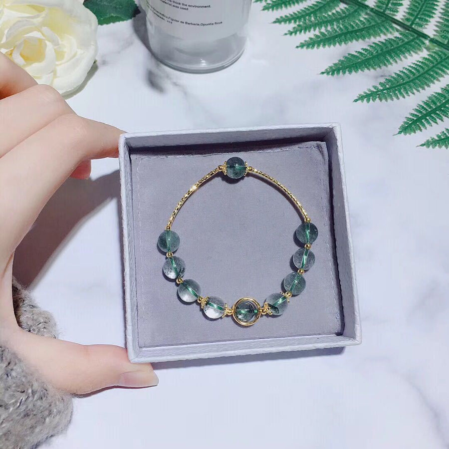 Gold-tone bracelet with green phantom crystal beads in a grey gift box