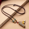 Gold-tone cylindrical pendant with engraved mantras on a braided brown cord