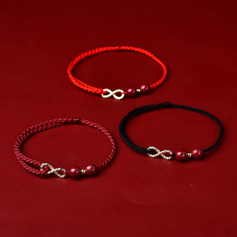Three braided bracelets with infinity charms on a red background