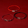 Three braided bracelets with infinity charms on a red background