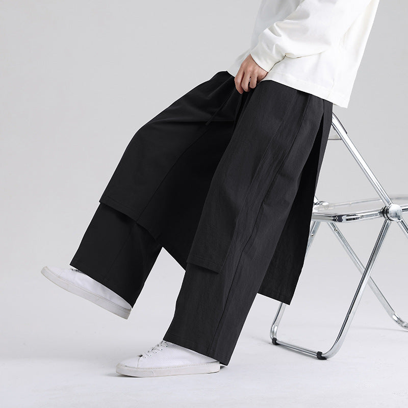 Man wearing loose black cotton linen pants with side pockets
