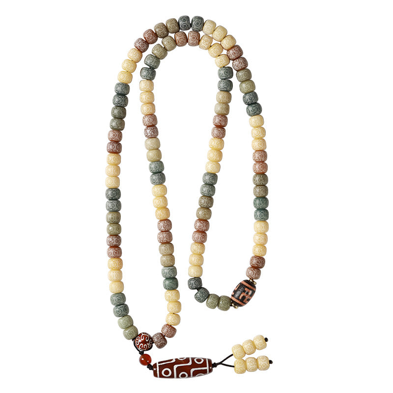 Close up view of a multi-colored bodhi seed mala necklace with a red agate dzi pendant