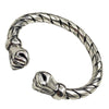 Silver tone twisted open cuff bracelet with animal head terminals on white background