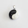 Round white turquoise pendant with black Yin Yang symbol on silver-tone bail