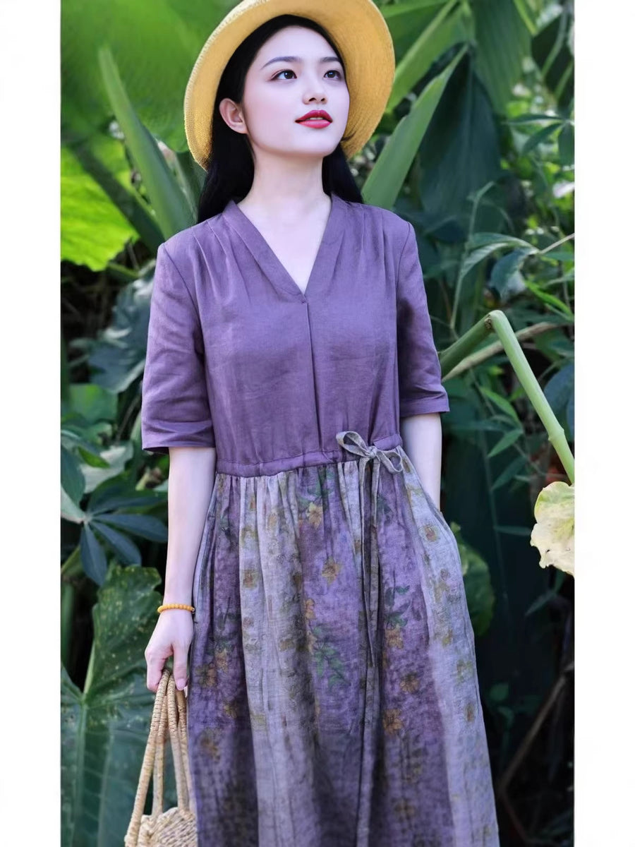 Woman wearing a purple cotton linen midi dress with a floral skirt in a garden setting