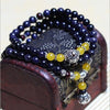 Close-up of blue sandstone bead bracelet wrapped around a wooden box