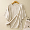 Beige loose-fit short sleeve linen t-shirt hanging on a wooden hanger