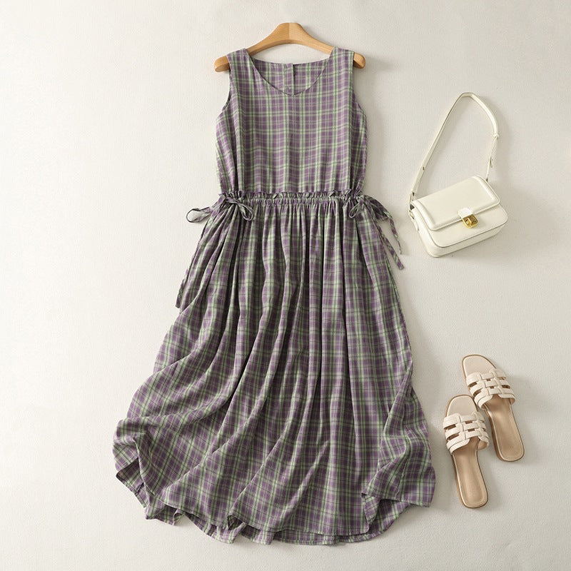 Purple and green plaid sleeveless dress on a wooden hanger