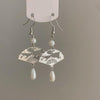 Silver-tone copper earrings shaped like fans with cloud patterns and pearl drops