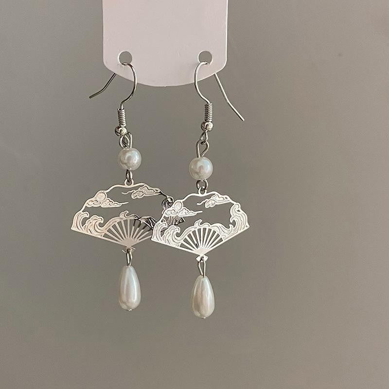 Silver-tone copper earrings shaped like fans with cloud patterns and pearl drops