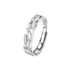 Two hands wearing silver tone rings with textured animal patterns