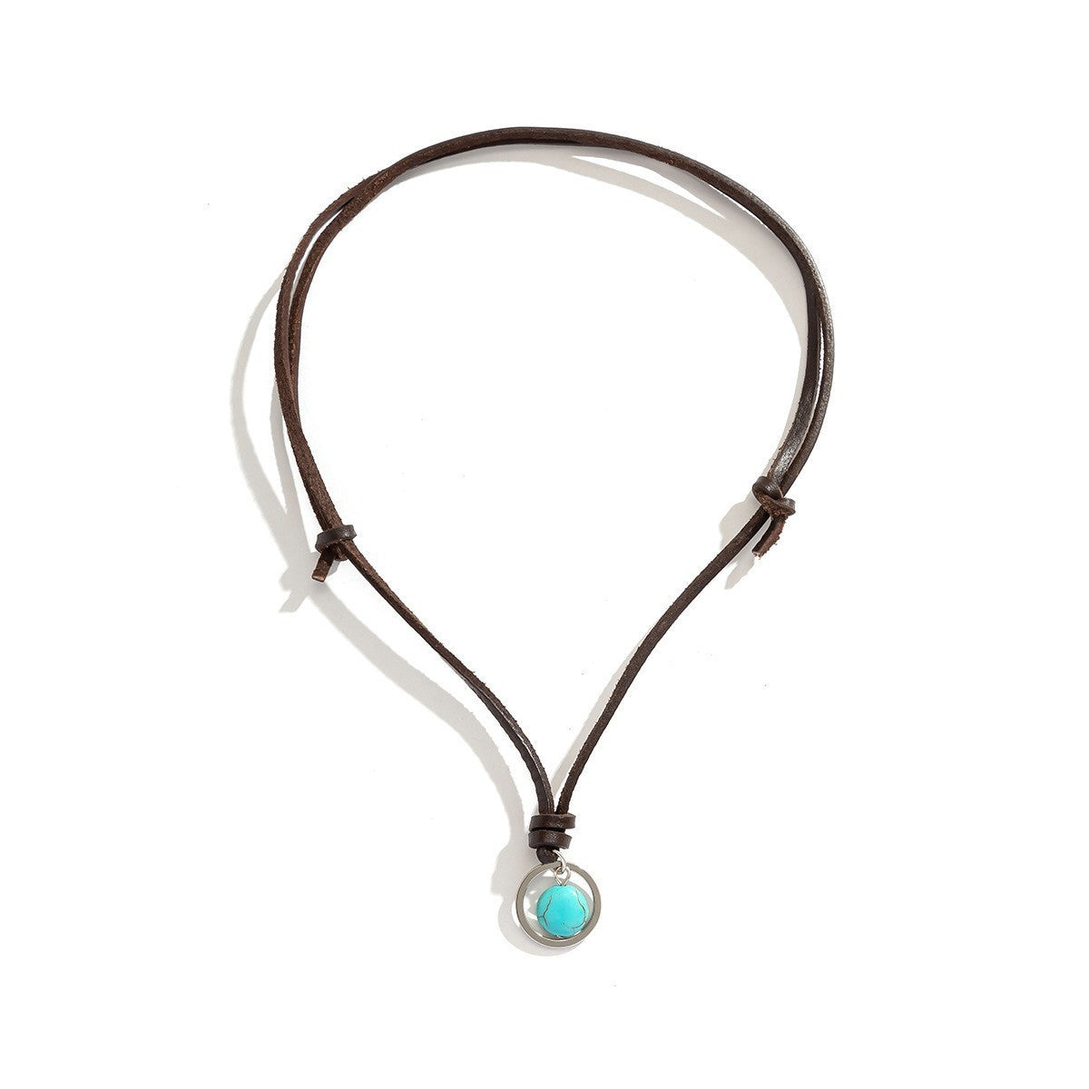Close up of a person wearing a necklace with a round blue stone pendant on a black cord.