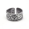 Close up of a silver adjustable ring with a lotus flower design and text engraving