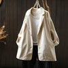 Beige women's cotton blazer jacket hanging on a wooden hanger