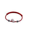 A red woven cord bracelet with a central silver goat charm and two dark beads
